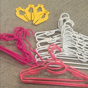 Pink and White Plastic Hangers with Yellow Size Dividers for baby / small child